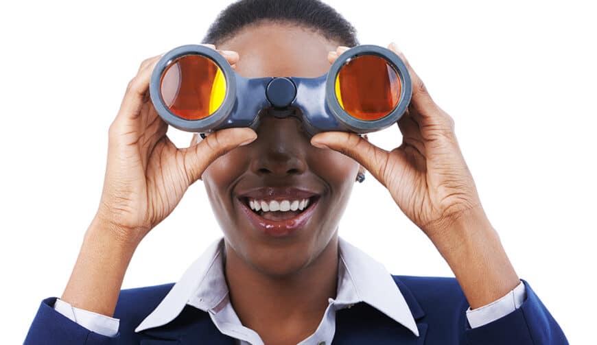 Success is on the horizon. Shot of a young african american businesswoman holding binoculars